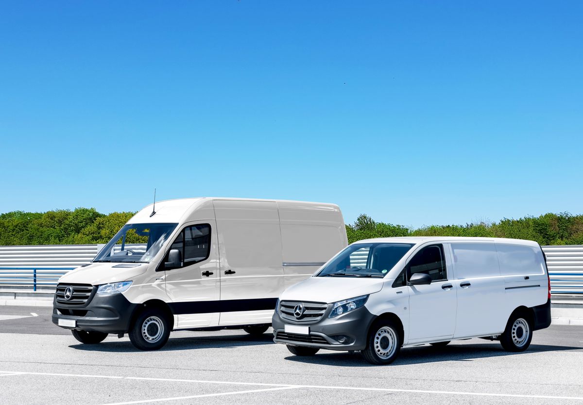 Two white commercial cargo vans parked together